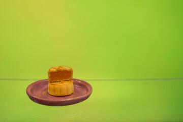 Moon cake with pretty background, a traditional food, cuisine, or snack for Chinese or Asian  Mid-Autumn festival 