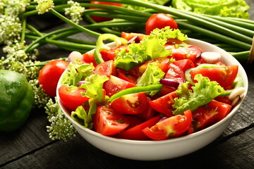 Homemade organic tomato green vegetable  salad served in white ceramic bowl. diet meal.