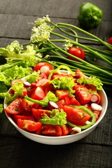 Homemade organic tomato green vegetable  salad served in white ceramic bowl. diet meal.
