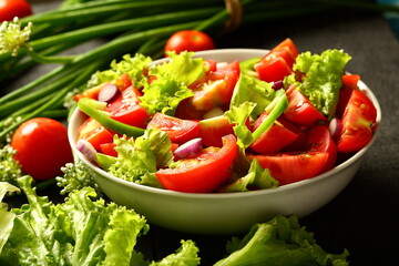 Homemade organic tomato green vegetable  salad served in white ceramic bowl. diet meal.