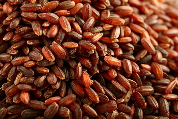 Macro, close up photograph of organic red, brown rice grains., healthy eating concepts.