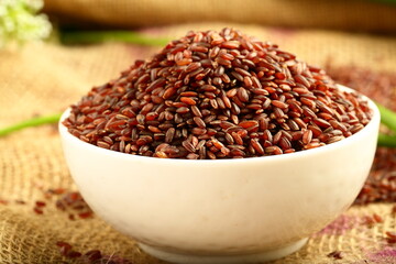 Bowl of red, brown, organic rice grains, 