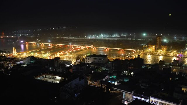 Beautiful Night View of Haridwar city during largest Indian festival Kumbh Mela. Bank of Ganga River is lit up with lights. The Holy River of India. High quality 4k footage