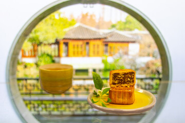 Moon cake with pretty background, a traditional food, cuisine, or snack for Chinese or Asian  Mid-Autumn festival 