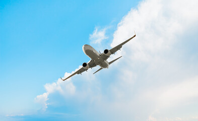 White passenger airplane over the clouds  - Travel by air transport