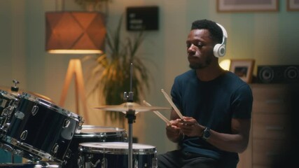 African American drummer rehearsing in evening