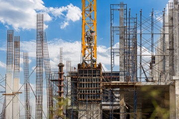 Working at height equipment with bucket liquid concrete container. Construction worker working on a...