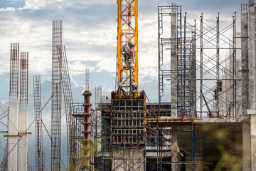 Working at height equipment with bucket liquid concrete container. Construction worker working on a...