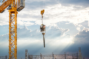 Working at height equipment with bucket liquid concrete container. Construction worker working on a...