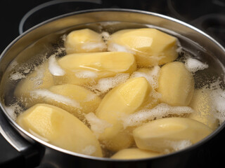 Cooking potatos in boiling water in saucepan