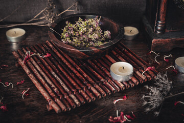 Wooden bowl filled with dried thyme on wiccan witch altar for casting a spell. Free space for text...