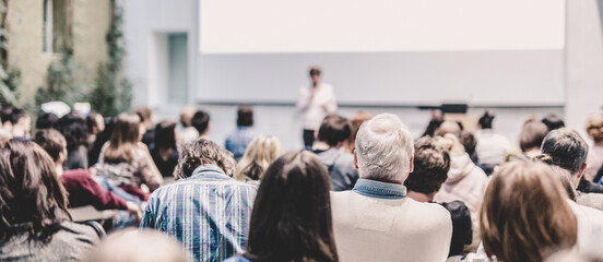 Woman giving presentation on business conference.