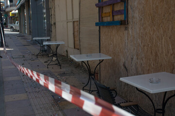 Heraklion, Crete, Greece, September 28 2021: A day after the catastrophic earthquake 5,8 magnitude at the town of Arkalochori. Debrison the street. Tables outside a coffee shop.