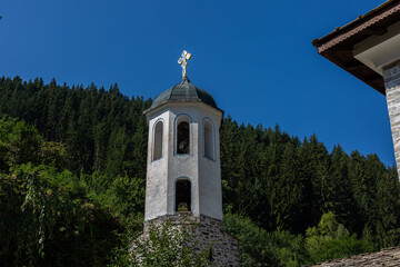 Fototapeta na wymiar Bell tower of church and trees on the background