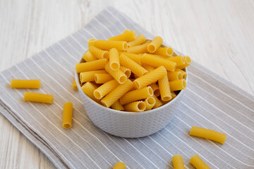 Dry Rigatoni Pasta in a gray Bowl, low angle view.