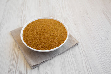 Organic Brown Sugar in a White Bowl, low angle view. Space for text.