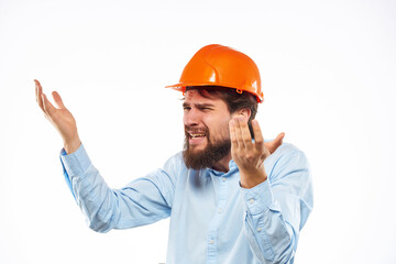bearded man orange helmet on the head protective uniform