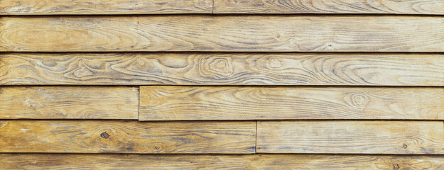 panoramic view of an old and worn acacia wood plank. wood grain very marked. colour sand. banner and graphic resources