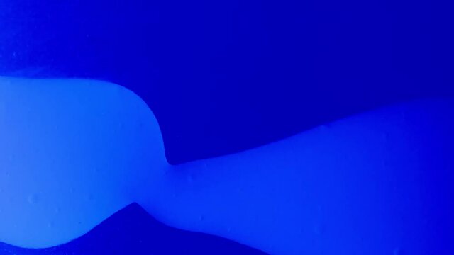 closeup of blue blobby lavalamp. liquid is moving from right to left.