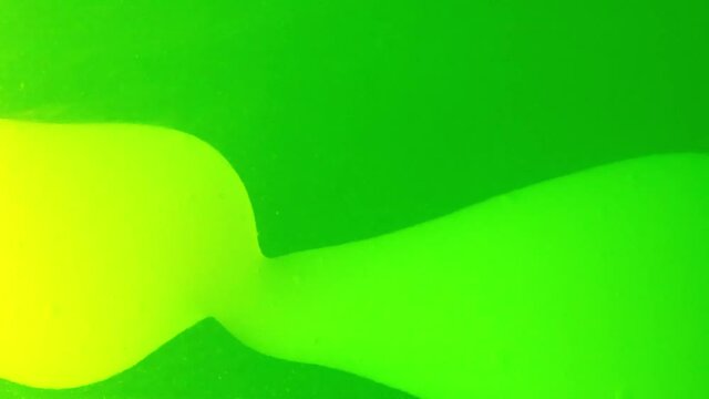 closeup of green blobby lavalamp. Slime is moving from right to left