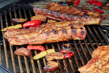 Large cuts of grilled meat with vegetables
