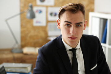 Handsome businessman in suit portrait at workplace