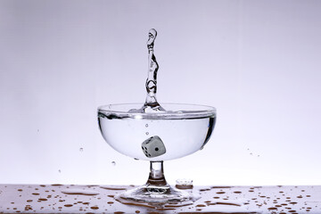 Dice falling into the water with splashes