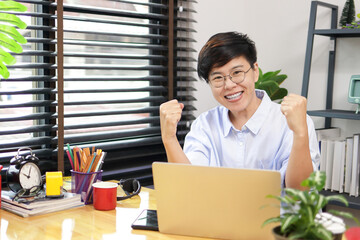 Asian woman with short hair wearing glasses working at home Run a business selling trees online. Smile, glad to be able to sell the tree. entrepreneurial concept, doing business online