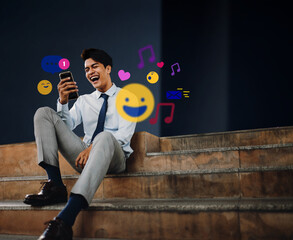 Cheerful Young Asian Businessman Using Mobile Phone in the City. Enjoying Social Media application. surrounded by many icons
