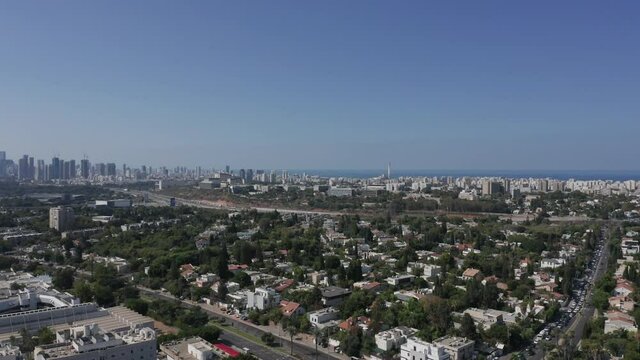 Tel Aviv northern Tel Baruch skyline, with traffic and low build houses.
