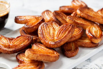 Puff pastry cookies palmier or elephant ears, caramelized and crunchy pastry. White background