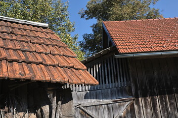 Fototapeta na wymiar Shed roofs with old and new tiles