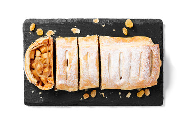Traditional homemade apple strudel with caramelized apples and raisins. isolated on white...