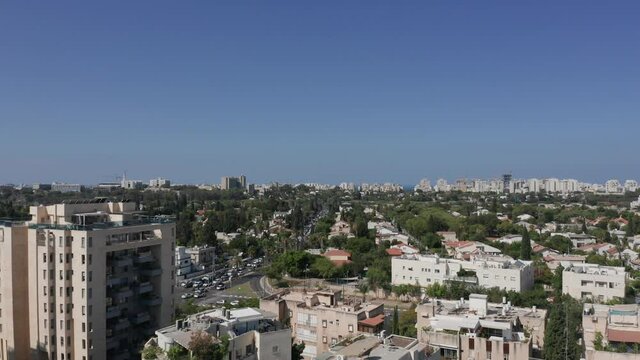 Tel Aviv northern Tel Baruch skyline, with traffic and low build houses.
