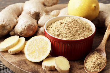 A bowl full of dry ginger, with fresh ginger, lemon and mint.