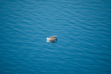 Far view of boat on the sea near the Makarska city, Croatia.