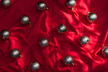 Golden christmas balls on red textile. Christmas background.