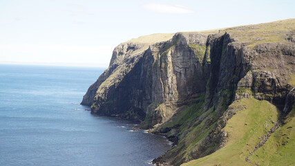 Fototapeta na wymiar Rugged sea and cliff landscapes on Suðuroy Island in the Faroe Islands of Denmark.