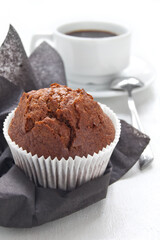 Chocolate muffin with cup of coffee on the white background