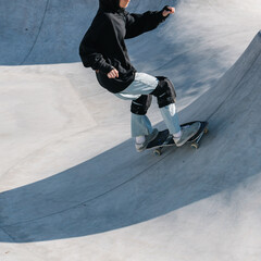 Fototapeta na wymiar Skateboarding outdoor. Skater skating in an urban concrete skatepark