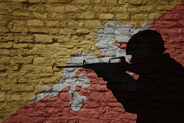 Soldier silhouette on the old brick wall with flag of bhutan country.