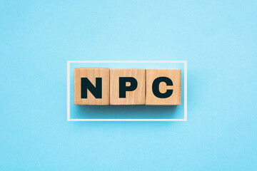 Wood cubes with acronym 'NPS' - 'net promoter score' on a beautiful blue background. Business concept, copy space.