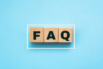 FAQ abbreviation on wooden cubes on blue. Frequently Asked Questions. Business concept.