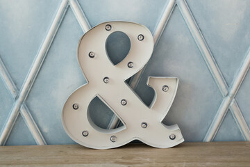 ampersand sign on wood table. Interior and furniture concept. - obrazy, fototapety, plakaty