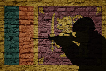 Soldier silhouette on the old brick wall with flag of sri lanka country.