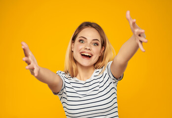 cute blonde girl in striped t-shirt fun attractive look yellow background