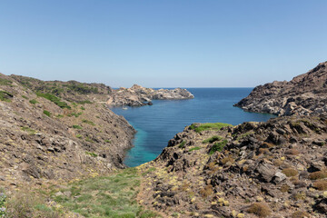 Fototapeta na wymiar boat in a cove of cap de creus in girona a sunny summer day with blue sea