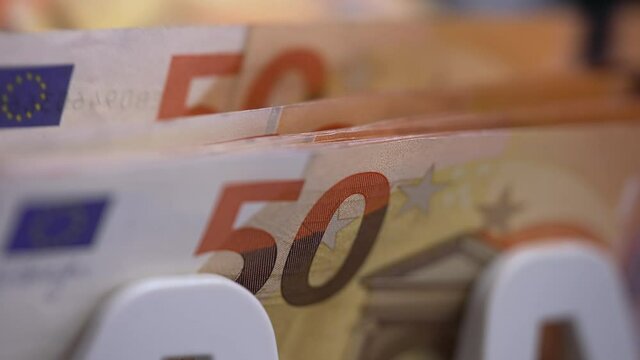 Close up of euro banknotes while counting. Financial money currency counting machine.