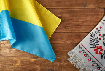 Ukrainian still life with traditional elements: flag of Ukraine, national embroidery and viburnum berries on a wooden background