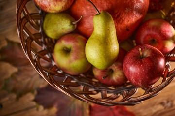 Autumn still life with fruits and vegetables: apples, pears and pumpkin on fallen leaves